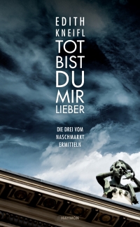 Buchcover: Farbphotographie, Blick nach oben, Fassadendetail und dunkle Wolken, darauf weiße Schrift